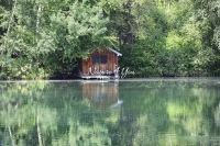 Lake house surrounded with trees and water reflections in Bavaria