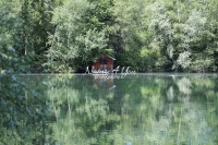 Lake house surrounded with trees and water reflections in Bavaria