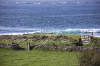 Farm gates in the countryside above ocean breakers in Normandy