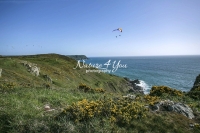 Paragliding over the coast and ocean in Normandy